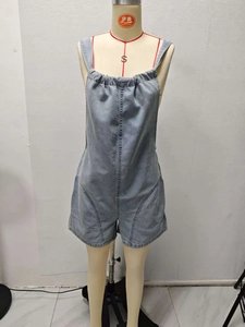 Detail of adjustable straps and ruched neckline on light blue denim summer romper jumpsuit