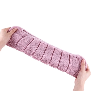 Universal pink plush toilet seat cover being stretched to show flexibility and soft texture
