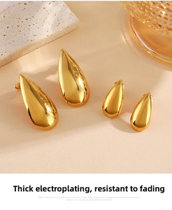 Macro detail of high-polish gold teardrop earrings in small and large sizes
