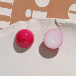 Macro view of dome-shaped resin heart beads in vibrant pink and soft pastel tones