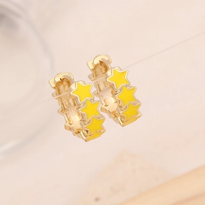 Golden hoop earrings with yellow enamel stars shown hanging on light pink background