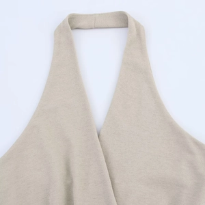 Detailed view of apricot textured knit halter neck design on a chic spring dress