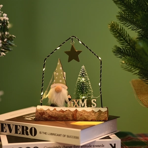 Detail of a Christmas gnome with warm LED light in a metal frame on wood base