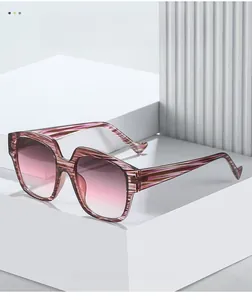 Detailed close-up of textured pink striped sunglasses frame with gradient lenses