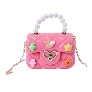 Pink silicone jelly handbag for kids with pearl handle, gold chain, and cute cartoon charms