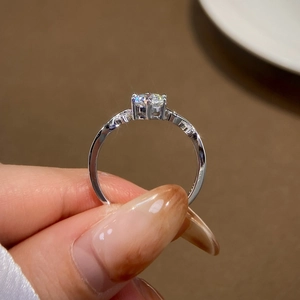 Classic six-prong moissanite ring with round-cut sparkling stone and silver band