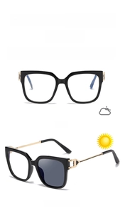 Detail of cat-eye frames with golden temples showing light-sensitive color-changing effect
