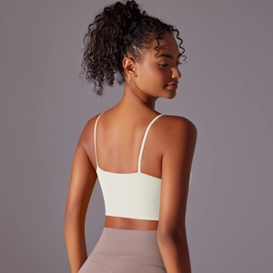Detail of cross back straps and nylon fabric on cream high-impact sports bra