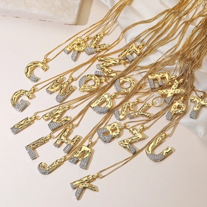 Two-tone alphabet pendant necklace featuring gold and silver plating with zircon pavé