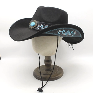 Detail of black cowboy hat with turquoise stone and blue floral embroidery on the brim