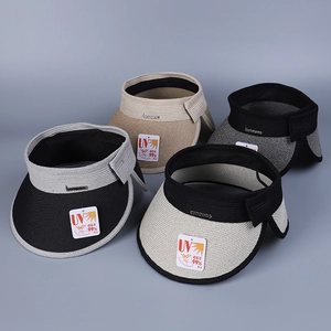 Close-up of four straw sun visors with wide brims and metallic brand logo details