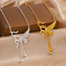 Detail of silver and gold perfume bottle necklaces with tassels on silk background