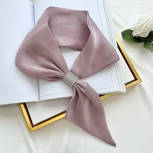 Detail of mauve satin scarf featuring a sparkling rectangular rhinestone buckle ornament