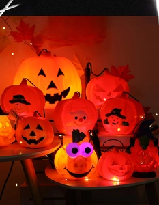 Close-up of LED pumpkin lanterns with classic jack-o'-lantern faces and witch hats