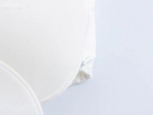 Close-up of a white floral dress showing breathable mesh fabric and a hidden zipper detail