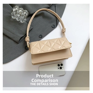 Detail of beige quilted crossbody bag with knot strap and metallic gold hardware