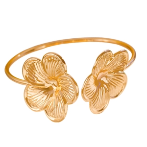 Gold open bangle featuring two detailed 3D floral accents with elegant metal textures