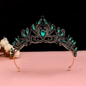 Detailed baroque crown featuring vintage bronze frame with emerald and black rhinestones