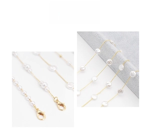 Close-up of golden pearl eyewear chain featuring lobster clasp and white pearls