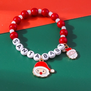 Detail of Christmas beaded bracelet with SANTA BABY letter beads and Santa Claus charms