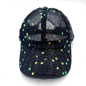 Detailed macro view of black mesh baseball cap with 3D floral patches and sequins