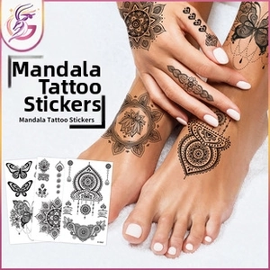 Detail of mandala butterfly temporary tattoos with bohemian floral patterns and heart motifs
