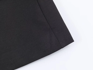 Detailed macro view of black twill fabric texture and neat stitching on blazer hem