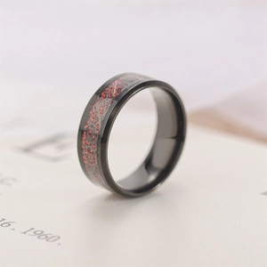 Close-up of black stainless steel ring with red dragon pattern inlay