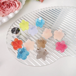 Set of 10 colorful flower and star mini hair claws in vibrant macaron jelly colors