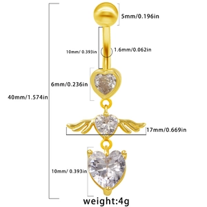 Close-up of golden heart and angel wing navel ring with detailed size measurements