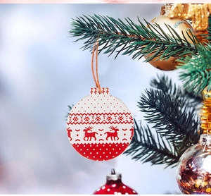 Close-up of Nordic style wooden Christmas tree ornament with deer and snowflake patterns