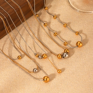 Two-tone stainless steel necklaces with round bead pendants and gold snake bone chains