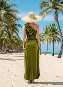 Detail of green velvet one-shoulder dress featuring back rope knot in a beach setting