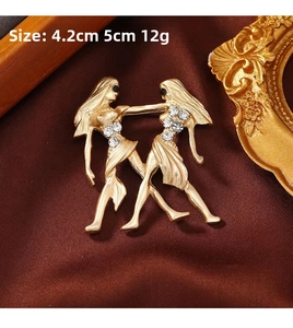 Detailed view of a gold-plated vintage dancer brooch with sparkling white rhinestones