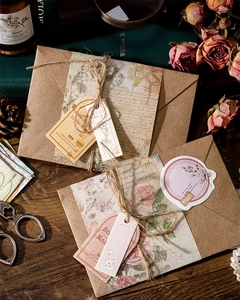 Vintage plant themed stationery set with envelopes and tags on retro wood background