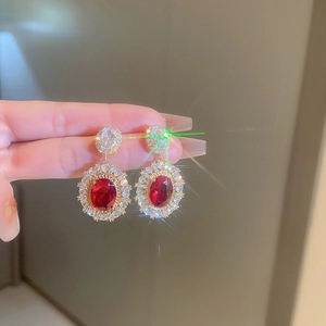 Luxurious vintage palace style gold earrings with oval red gems and white zircons