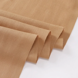 Close-up of khaki scarf fabric showing thick twill weave texture and high quality material