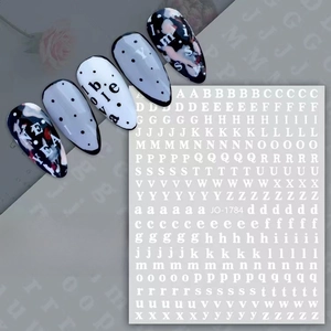 Detailed view of classic letter nail decals featuring black and white typography patterns