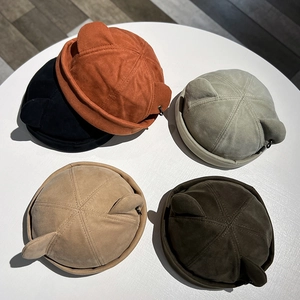 Cat ear miki hat in suede finish, flat lay view of multiple colors on a round table
