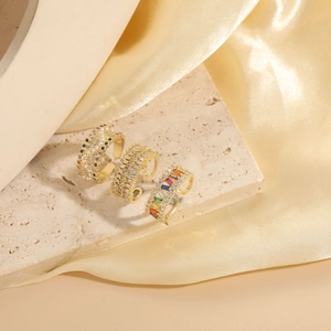 Detailed view of three 14K gold plated rings with pearls and colorful zircon stones
