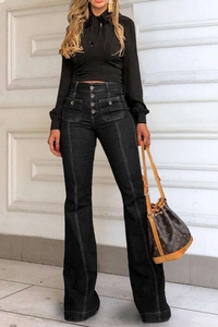 Detail of high waisted flare jeans featuring a four-button fly and slim fit black denim