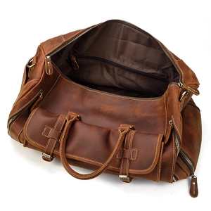 Top view of vintage brown leather travel bag interior with a secure zipper pocket