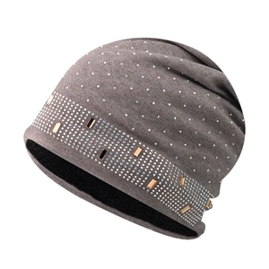 Detailed view of women's knitted beanie with rhinestones and warm fleece lining inside