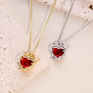 Gothic style heart necklace with red crystal pendant and crown detail in gold and silver