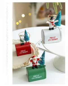 Three festive Christmas metal mailbox ornaments with Santa, snowman and bear figurines