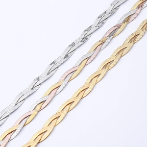 Detailed view of woven herringbone chains in silver, two-tone, and tri-color finishes