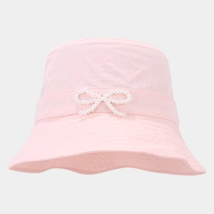 Close-up of pink bucket hat featuring a delicate pearl bow and wavy brim detail