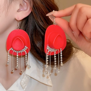 Hip-hop style red cowboy hat earrings with sparkling rhinestone tassels on model