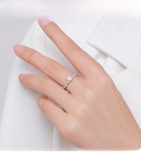 Detail of S925 silver ring featuring a pink heart stone and small zircons on finger