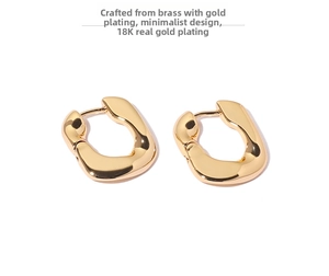 Macro detail of chunky irregular hoop earrings with 18K gold plated polished finish